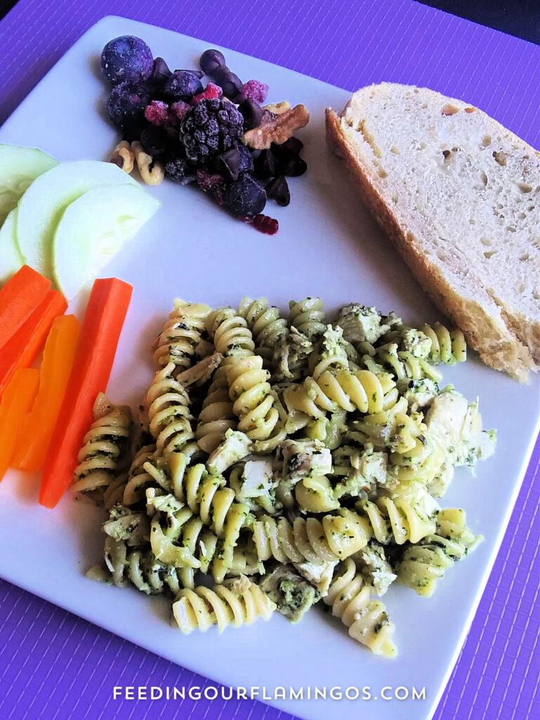 Quick and easy meals: pesto pasta with chicken, artisan bread, veggies and dip, and a berry nutty chocolate treat